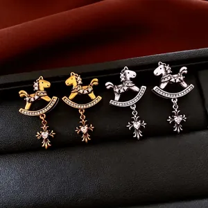 Vintage rocking horse earrings with cubic zirconia and cross charms on black leather