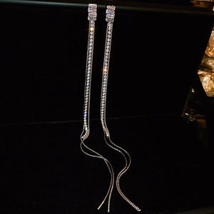 Elegant zircon tassel earrings in silver finish with sparkling rhinestones on black background