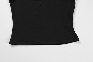 Detail of the high-quality double-needle stitching on a black knit crop top hem