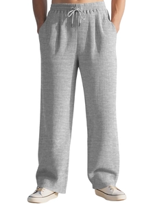 Detail of grey striped corduroy pants showing elastic waistband and white drawstring
