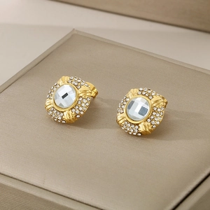 Detail of 18k gold plated oval stud earrings with clear crystal and pave rhinestones
