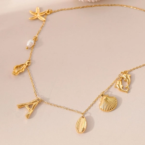 Detail of 18k gold plated necklace with freshwater pearl, starfish and A letter charms