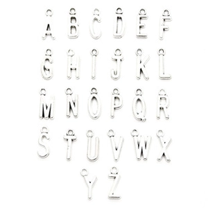 Macro view of complete A-Z alphabet metal charms set in bright silver for DIY jewelry