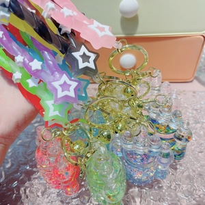 Close-up of star silicone wristbands and luminous liquid quicksand bottle keychains