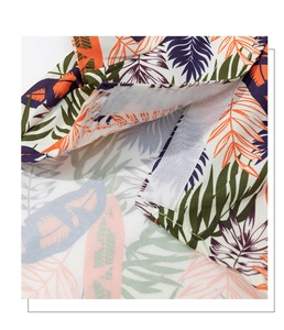 Close-up of tropical leaf print dog shirt with durable white hook and loop fastener