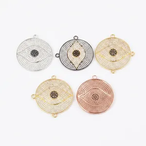 Macro detail of four large evil eye disk pendants with micro-pave crystals and ruler scale