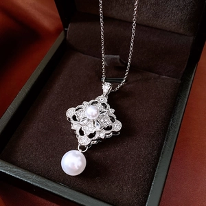 Detail showing vintage lace hollow pendant with zircon pave and white pearls