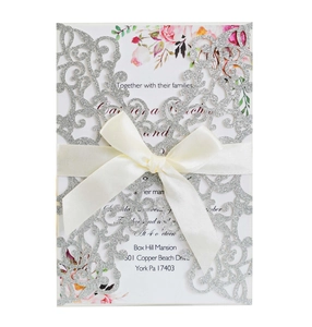 Laser-cut silver glitter wedding invitation with beige satin ribbon and floral insert card