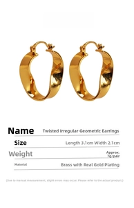 Macro detail of twisted irregular geometric brass earrings with real gold plating