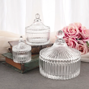European glass candy jars set of three with ribbed relief patterns and ball handle lids