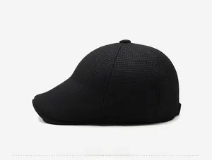 Side view of men's winter newsboy cap in black waffle knit with metal Style logo detail