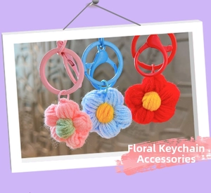 Detailed view of handmade crochet flower keychains in pink, blue and red with plastic clips