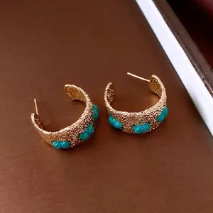 Vintage gold-plated C-shaped earrings with hammered texture and blue silk thread accents