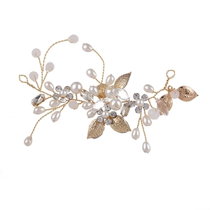 Elegant gold bridal hair vine with artificial pearls, crystals, and metallic leaves