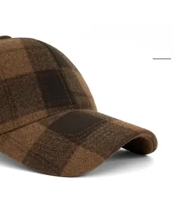 Detail of a brown plaid wool baseball cap showing the foldable and widened brim