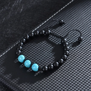 Close-up of adjustable braided bracelet with 8mm matte beads and three turquoise stones