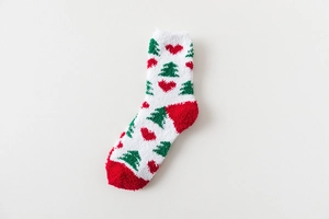 Detail of soft coral fleece Christmas sock with festive tree and heart patterns