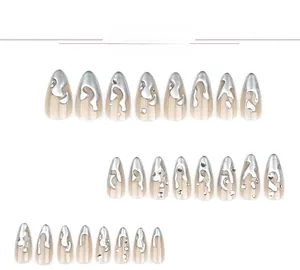 Macro shot of nude almond press-on nails featuring silver 3D liquid metal and rhinestones