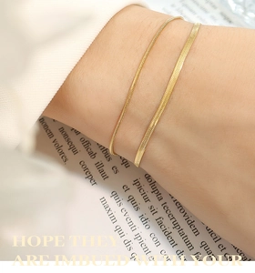 Close-up of double-layered gold-plated titanium steel snake chain bracelet on wrist