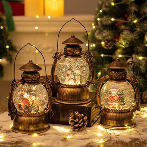 Vintage gold Christmas lantern music box with swirling snow and Santa Claus figures