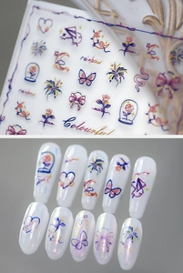 Macro detail of rainbow and butterfly nail stickers with colorful line patterns on pearls