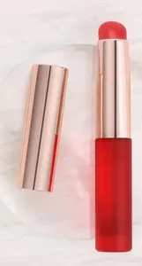 Detail view of round silicone lip brush with dust cover and rose gold metal finish