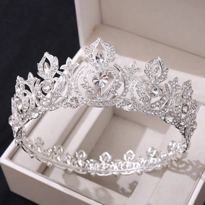 Macro shot of silver wedding crown with clear crystals in a jewelry box on black background