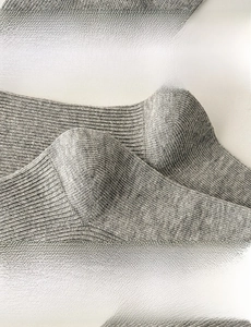 Detail of grey crew socks showing elastic cuff design and ergonomic reinforced heel structure