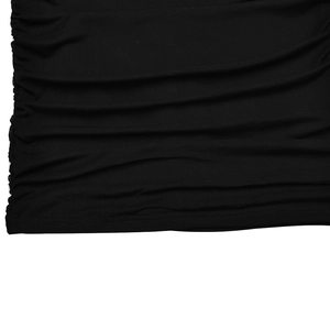 Close-up of black fabric texture showing elegant pleated details and soft elastic material