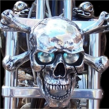 Close-up of chrome skull motorcycle headlight with integrated glowing bulb eyes