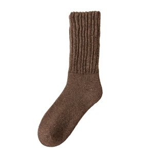 Thick brown wool crew socks for men with ribbed cuffs on white background