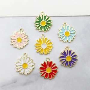 Detail view of colorful enamel daisy flower pendants for DIY jewelry and hair accessories