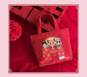 Close-up of red wedding canvas tote with traditional Chinese Xi character and cartoon pattern