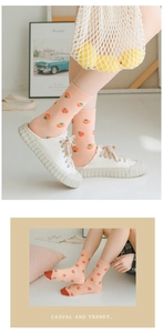 Detail of trendy cotton socks with peach apricot colors and strawberry tomato patterns