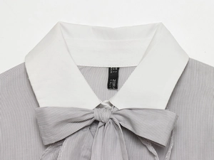 Close-up of grey striped shirt featuring a white collar and bow knot detail