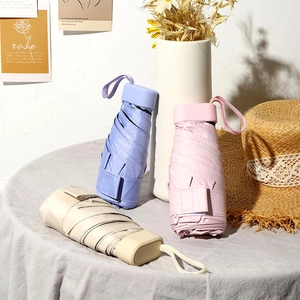 Mini folding pocket umbrellas in purple pink and beige compact sun and rain protection