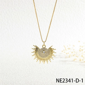 Detailed close-up of a gold sun pendant necklace with zircon inlay and box chain