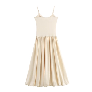 Elegant beige French slip dress with pleated skirt and slim waist on white background