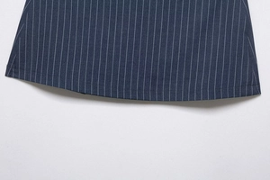 Detailed close-up of dark blue fabric with white pinstripes and hem stitching detail