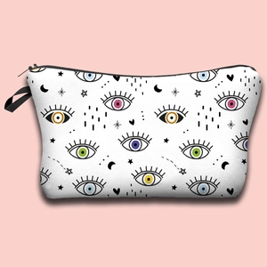 Detail of waterproof makeup bag with colorful evil eye patterns on pink background