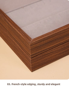 Detailed close-up of walnut wood jewelry box featuring refined French edge binding design