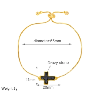 Detailed view of adjustable gold-plated chain bracelet with druzy stone cross pendant