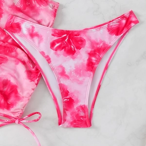 Detailed close-up of high-waisted floral bikini bottoms with vibrant hibiscus prints