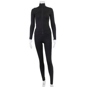 Detail of black sports set featuring a slim-fit zipper jacket and leggings on a mannequin