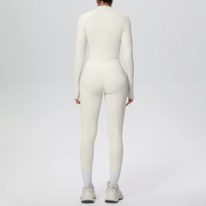 Rear view of sleek off-white three-piece yoga set showing slim fit leggings and jacket