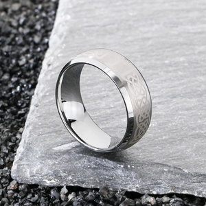 Detail of silver tungsten ring with Celtic knot etching and polished mirror edges