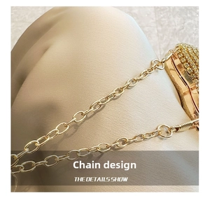 Detailed macro view of sparkling champagne gold rhinestones and elegant metal chain strap