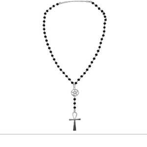 Detail of gothic black beaded necklace with silver pentagram and Ankh cross pendant