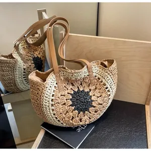 Close-up of handmade hollow paper rope woven tote with blue sunflower pattern and leather straps