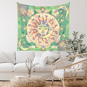 Detailed view of bohemian sun and moon tapestry with zodiac symbols on a white wall